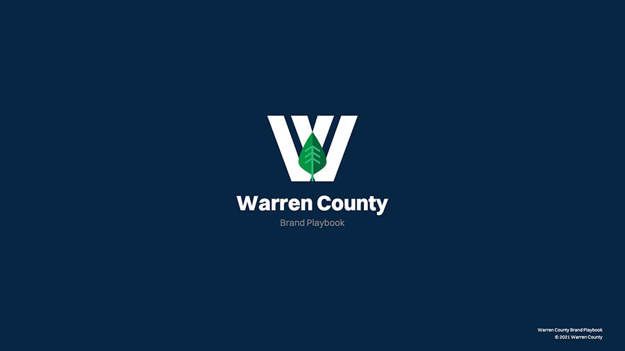 Warren County brand playbook cover with white logo over navy blue gradient background